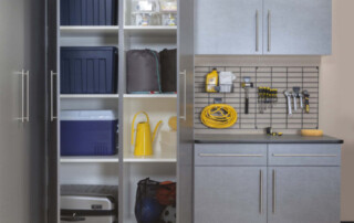 A custom garage with Pewter cabinetry boasting a great organization system.