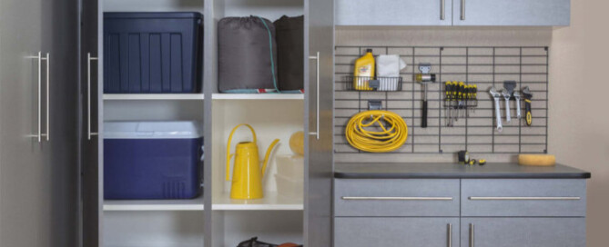 A custom garage with Pewter cabinetry boasting a great organization system.